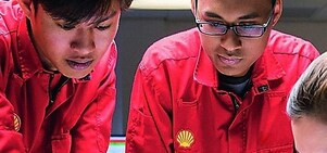 Three employees reviewing plans