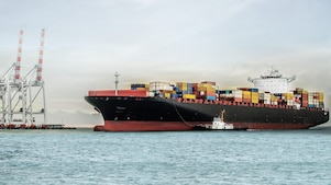 large tanker at sea loaded with container crates