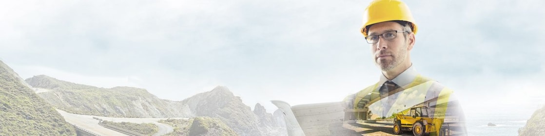 A worker in a yellow hard hat transposed onto a background og a road in some mountains