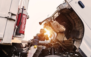 man-checking-truck-engine