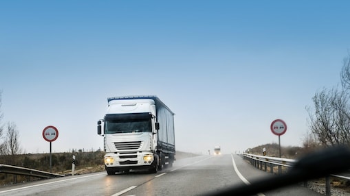 road with two heavy trucks coming