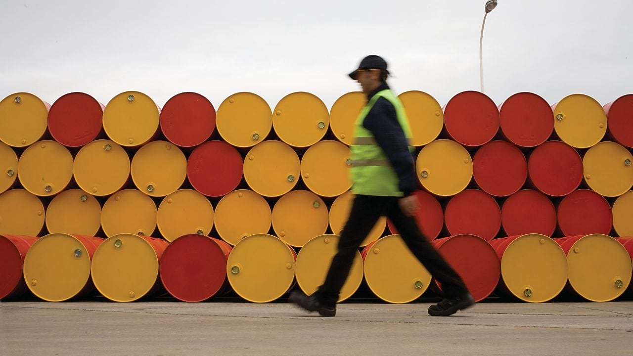 man walking barrels lubricants