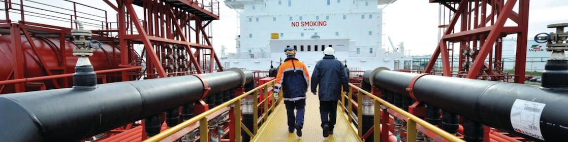 Shell employee walking along on a tanker 
