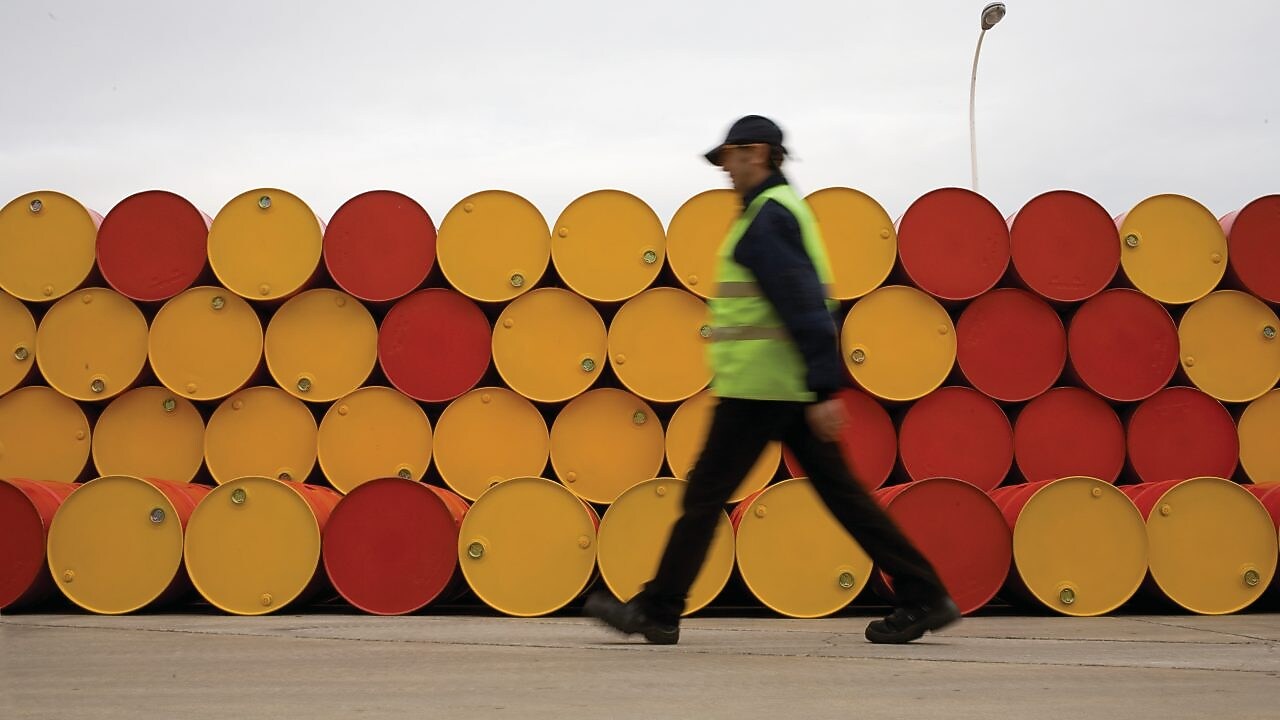 man walking barrels lubricants